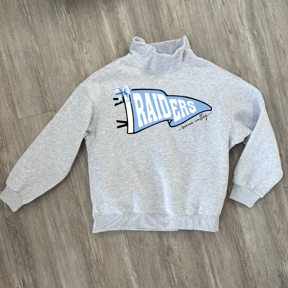 A light heather gray long-sleeve mock neck sweatshirt with a blue and white 'Raiders' pennant graphic on the chest.