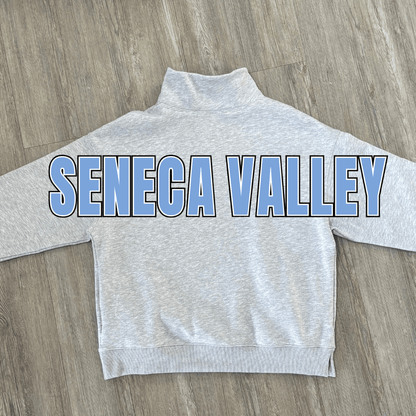 A light heather gray mock neck sweatshirt with 'SENECA VALLEY' printed across the back in light blue block letters with a black outline.